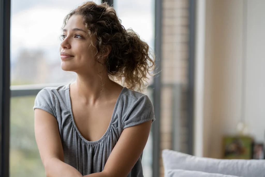 Portrait of a thoughtful woman at home looking nostalgic during the quarantine - lifestyle concepts